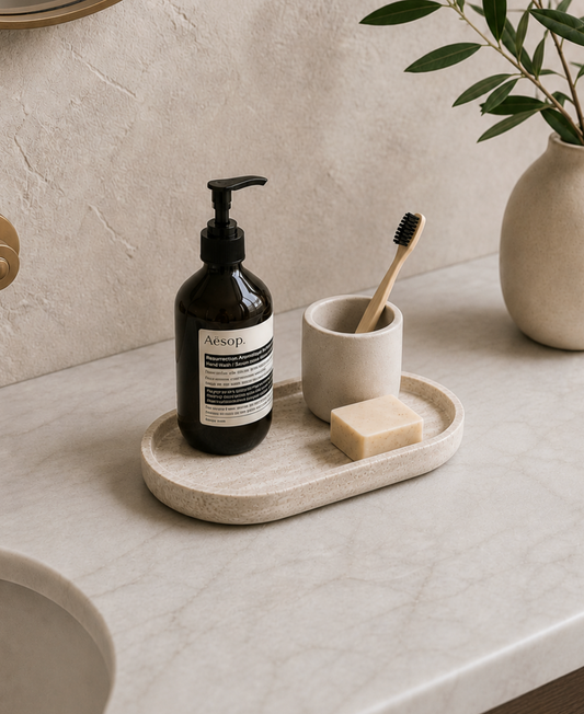 Bathroom counter with Aesop bottle, toothbrush, and soap on a tray