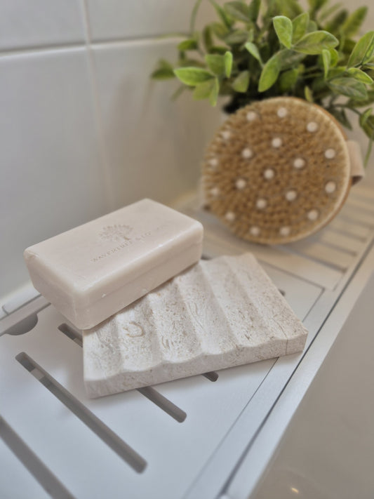 Bar of soap on a limestone soap holder