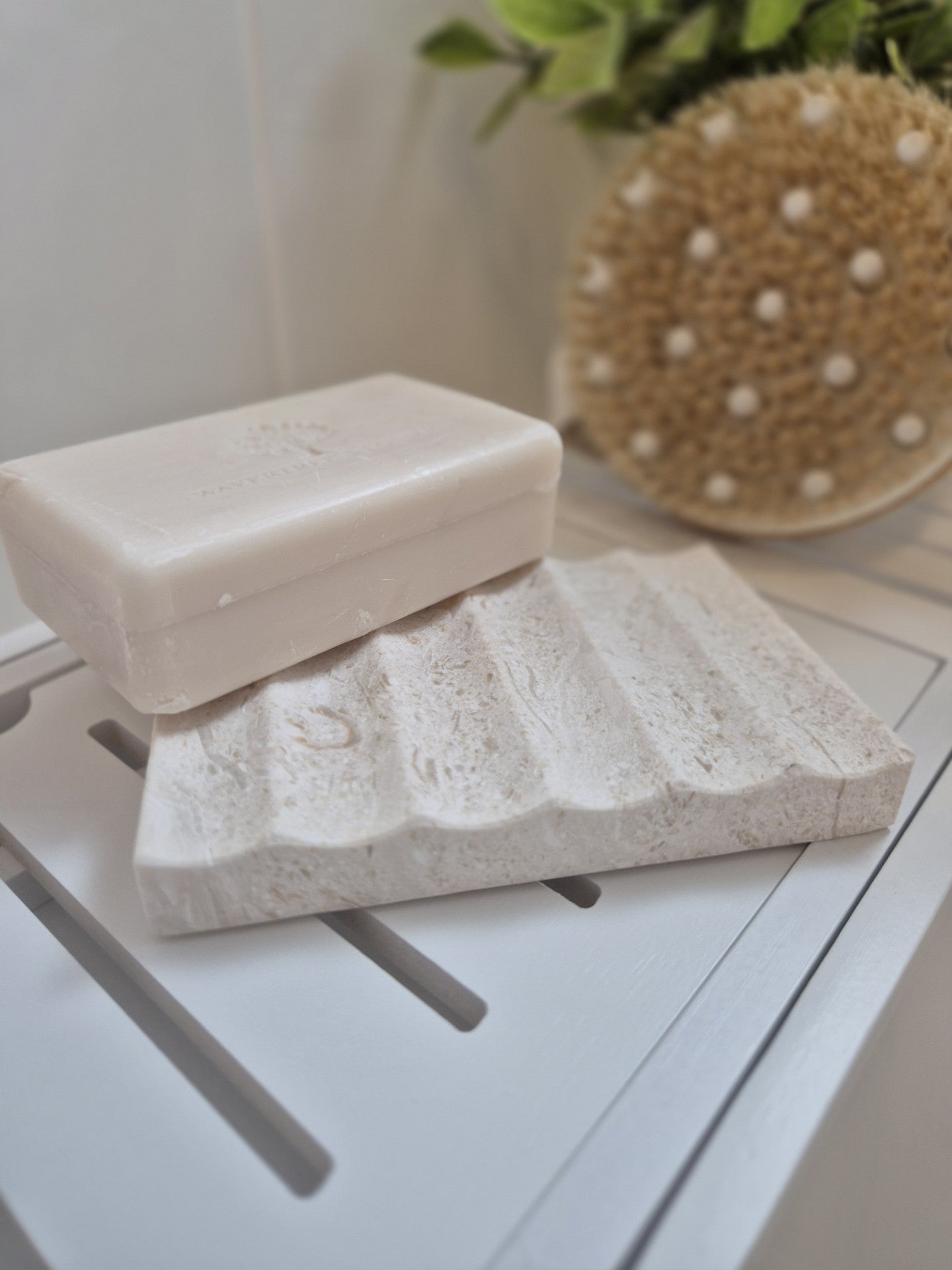 Close up limestone soap dish with drainage channels