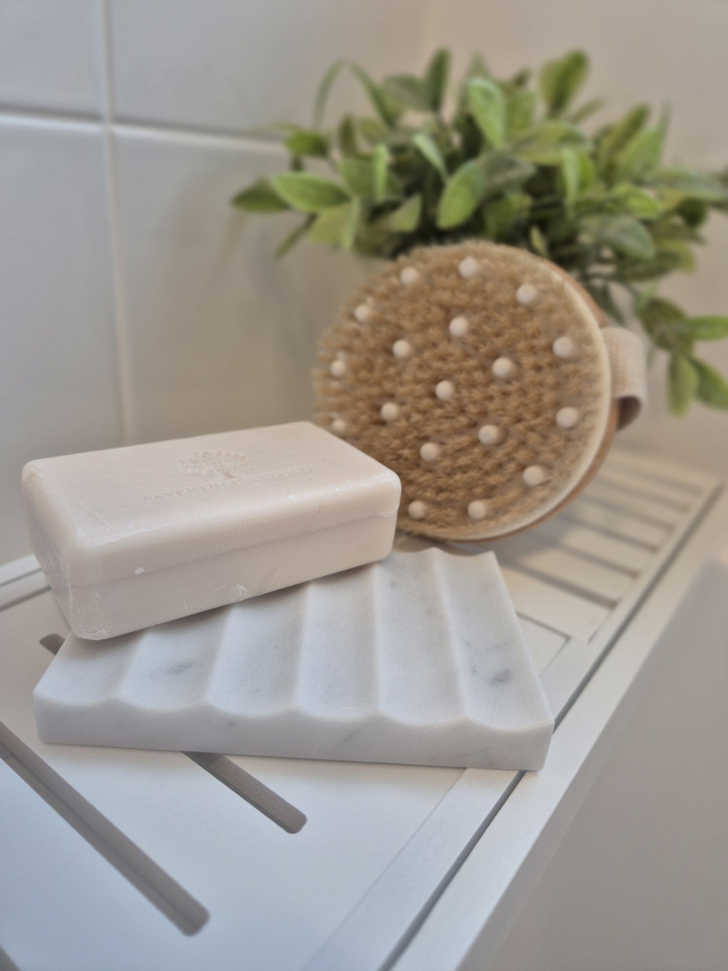 White marble soap dish on bathroom vanity